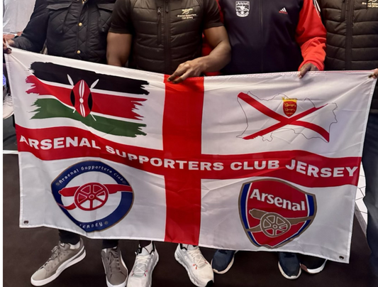 People holding a Arsenal Supporters Club jersey flag with the Arsenal logo.