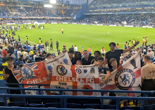 Supporters holding Chelsea FC banners at a stadium