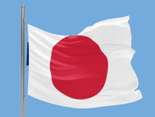 Flag of Japan waving against a clear blue sky