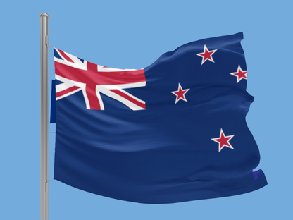 New Zealand flag waving against a clear blue sky