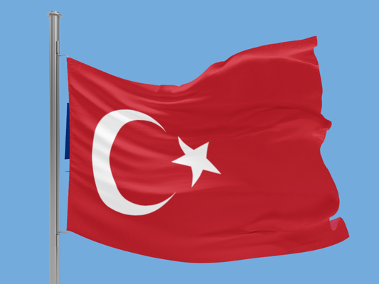 Turkish flag waving against a clear blue sky