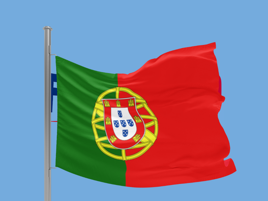Portuguese flag waving against a blue sky